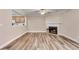 Living room boasts hardwood floors, a fireplace, and view into the kitchen at 2306 Queen Anne Ct, Atlanta, GA 30350