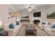 Inviting living room with fireplace, hardwood floors, and access to the kitchen at 2306 Queen Anne Ct, Atlanta, GA 30350