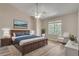 Spacious main bedroom with a large window, ceiling fan and ensuite bathroom at 2306 Queen Anne Ct, Atlanta, GA 30350