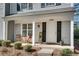 Inviting front porch with seating, lush landscaping and a welcoming entrance at 2306 Queen Anne Ct, Atlanta, GA 30350