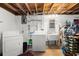 Basement laundry area with washer, dryer, sink, and storage at 945 Blackwell Rd, Marietta, GA 30066