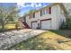 Charming two-story home with white brick, red trim, a two-car garage, and a concrete driveway at 945 Blackwell Rd, Marietta, GA 30066