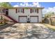 Attractive two-story home with white brick, red trim, two-car garage, and a paved driveway at 945 Blackwell Rd, Marietta, GA 30066
