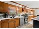 Well-lit kitchen featuring wooden cabinetry, stainless steel appliances and countertop with sink at 945 Blackwell Rd, Marietta, GA 30066