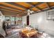 Relaxing sunroom featuring brick walls, ceiling fan, rug, and rustic wood decor at 945 Blackwell Rd, Marietta, GA 30066