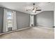 Bright bedroom features neutral carpet, a ceiling fan, and plenty of natural light from two windows at 4248 Brighton Nw Way, Kennesaw, GA 30144