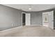 Spacious bedroom with neutral carpet, gray walls, and two doors leading to other rooms at 4248 Brighton Nw Way, Kennesaw, GA 30144