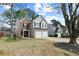 Well-kept home with a brick facade, complemented by a two-car garage and lush trees at 4248 Brighton Nw Way, Kennesaw, GA 30144