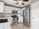 Bright kitchen features white cabinets, stainless steel appliances, granite countertops, and modern lighting at 4248 Brighton Nw Way, Kennesaw, GA 30144