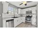 Well-lit kitchen features granite countertops, stainless steel appliances, and modern white cabinetry at 4248 Brighton Nw Way, Kennesaw, GA 30144