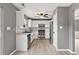 Modern kitchen boasts stainless steel appliances, white cabinetry, and granite countertops, illuminated by a ceiling fan at 4248 Brighton Nw Way, Kennesaw, GA 30144