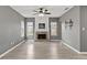 Spacious living room features light wood-look floors, brick fireplace, and large windows at 4248 Brighton Nw Way, Kennesaw, GA 30144