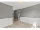 Spacious living room with wainscoting, hardwood floors, and neutral paint creating a calming atmosphere at 4248 Brighton Nw Way, Kennesaw, GA 30144