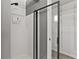 Modern shower with a glass door, rain shower head, and built-in shelving at 4248 Brighton Nw Way, Kennesaw, GA 30144