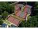 Aerial shot of tennis courts nestled in a lush, wooded area offering a private and scenic playing experience at 4248 Brighton Nw Way, Kennesaw, GA 30144