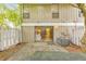 Relaxing backyard features a stone patio, grill, lush landscaping, and a slider into the living room at 664 Powers Ferry North Se, Marietta, GA 30067