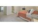 Bright bedroom showcasing a peach colored quilt, neutral paint, and a connected en suite bathroom at 664 Powers Ferry North Se, Marietta, GA 30067