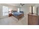 Bedroom with large windows, bedside table, lamp and view of the property at 664 Powers Ferry North Se, Marietta, GA 30067
