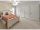 This bedroom offers a ceiling fan, neutral paint, large closets, and lots of natural light from the large window at 664 Powers Ferry North Se, Marietta, GA 30067