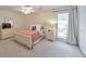 Cozy bedroom featuring a ceiling fan, neutral paint, and lots of natural light from the large window at 664 Powers Ferry North Se, Marietta, GA 30067