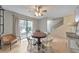 Bright dining room with hardwood floors that opens up to sliding doors and the staircase at 664 Powers Ferry North Se, Marietta, GA 30067