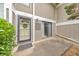 Close-up of the front entrance with decorative wreath, sliding glass door, and concrete patio at 664 Powers Ferry North Se, Marietta, GA 30067