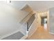 Bright hallway featuring wood floors, a carpeted staircase, and access to other rooms at 664 Powers Ferry North Se, Marietta, GA 30067