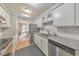 Traditional kitchen with granite countertops, tile backsplash, stainless steel appliances and access to dining area at 664 Powers Ferry North Se, Marietta, GA 30067