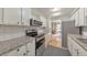 Well-lit kitchen with stainless steel appliances, granite counters, and white cabinetry at 664 Powers Ferry North Se, Marietta, GA 30067