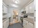 Galley kitchen featuring white subway tile, stainless appliances, and plenty of storage at 664 Powers Ferry North Se, Marietta, GA 30067