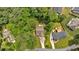 Aerial view of the property showcasing the landscaping, roof and driveway at 8166 N Pine Cone Dr, Villa Rica, GA 30180