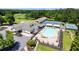 A bird's eye view of golf course, tennis courts, and an outdoor swimming pool at a recreational facility at 8166 N Pine Cone Dr, Villa Rica, GA 30180