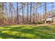 Spacious backyard with mature trees behind the house at 8166 N Pine Cone Dr, Villa Rica, GA 30180
