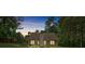 Evening shot of a backyard with illuminated windows at 8166 N Pine Cone Dr, Villa Rica, GA 30180