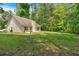Large, grassy backyard with house in view at 8166 N Pine Cone Dr, Villa Rica, GA 30180