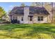 Exterior view of house showing backyard, patio, and well-maintained lawn at 8166 N Pine Cone Dr, Villa Rica, GA 30180