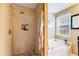 Tiled shower with built in storage nook located next to tub in this bathroom at 8166 N Pine Cone Dr, Villa Rica, GA 30180