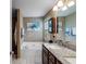 Bathroom featuring a granite sink, jetted tub and neutral colored walls at 8166 N Pine Cone Dr, Villa Rica, GA 30180