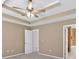 A bedroom featuring a ceiling fan, neutral paint, carpet flooring, and attached bathroom and closet at 8166 N Pine Cone Dr, Villa Rica, GA 30180