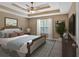 This bedroom features a large bed, a ceiling fan and a great view out the window at 8166 N Pine Cone Dr, Villa Rica, GA 30180