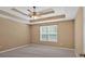A bedroom with a ceiling fan, a window, neutral paint, and carpet flooring at 8166 N Pine Cone Dr, Villa Rica, GA 30180