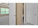 View of a spacious bedroom with fan and a glimpse of the bathroom at 8166 N Pine Cone Dr, Villa Rica, GA 30180