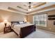Bedroom with trey ceilings, carpeted floors, two side tables, and a bright window at 8166 N Pine Cone Dr, Villa Rica, GA 30180