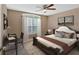 Bedroom with a large bed, a desk with a computer and chair, and a window at 8166 N Pine Cone Dr, Villa Rica, GA 30180