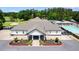 Aerial view of the clubhouse, golf course, tennis courts, and outdoor swimming pool at 8166 N Pine Cone Dr, Villa Rica, GA 30180