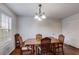 Traditional dining room with hardwood floors, chandelier, and space for entertaining guests at 8166 N Pine Cone Dr, Villa Rica, GA 30180
