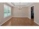 Open-concept dining room with hardwood floors and view of kitchen at 8166 N Pine Cone Dr, Villa Rica, GA 30180