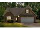 Beautiful home boasts a brick facade, attached two-car garage, and manicured front yard at 8166 N Pine Cone Dr, Villa Rica, GA 30180