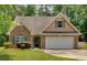 Charming single-Gathering home featuring a brick facade, attached two-car garage and well-manicured front lawn at 8166 N Pine Cone Dr, Villa Rica, GA 30180