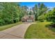 Desirable single-Gathering home featuring a brick facade, a two-car garage, and a lush, green lawn at 8166 N Pine Cone Dr, Villa Rica, GA 30180